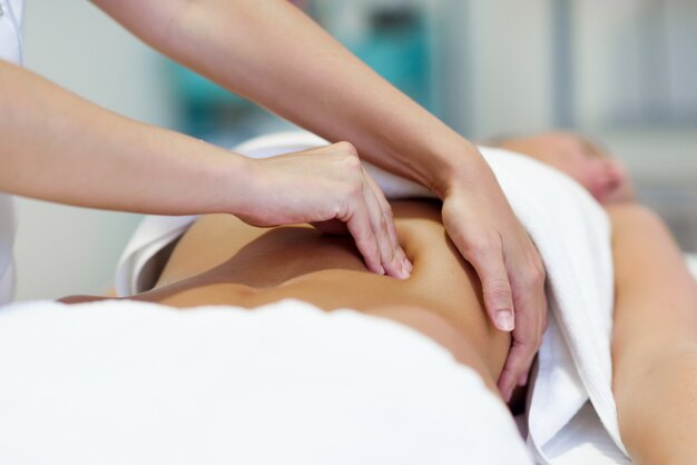 A woman enjoys a relaxing massage in a serene spa environment promoting wellness and tranquility